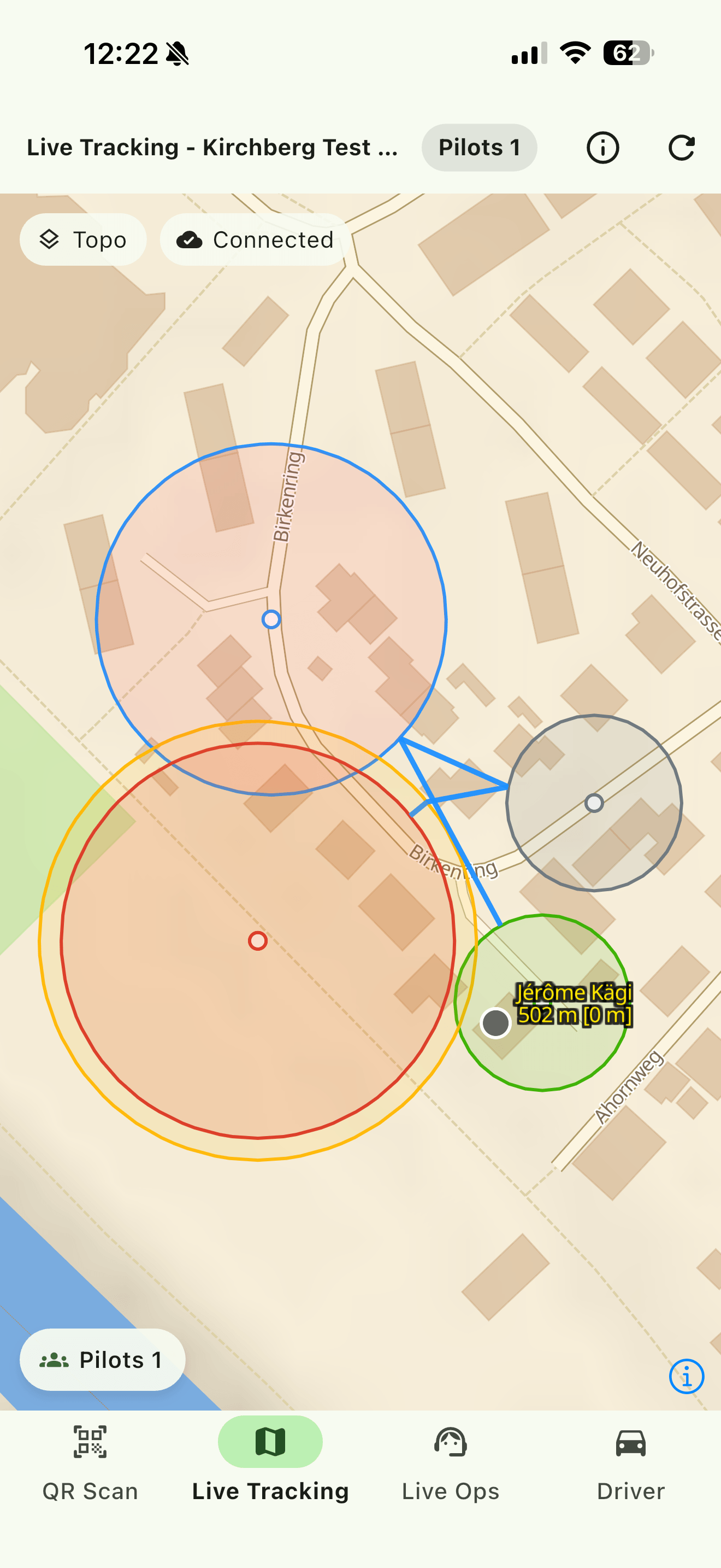 The live map. The optimized route runs in blue between the shapes, and the pilot's label carries their altitude with the height above ground in brackets. A real task covers valleys rather than streets: this one is a test task a few hundred meters across.